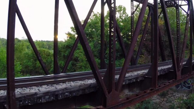 Aerial: Drone Panning Shot Of Railroad Track On Tranquil Truss Bridge - Buckner, California
