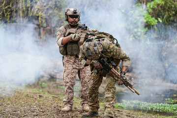 Soldiers in tactical gear aiming guns during a military exercise, showcasing teamwork and defense strategies.