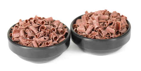 Delicious chocolate shavings in bowls isolated on white