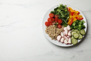 Vegetarian diet. Plate with tasty vegetables and quinoa on white marble table, top view. Space for text