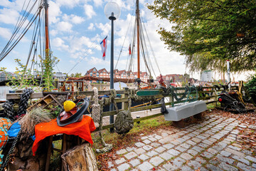 Idyllic river promenade with ships and fishermen decoration in Leer, Ostfriesland, Germany