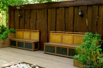 Wooden garden benches in the summer park