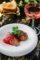 Delicious meat pate foie gras on plate with berry sauce, sprouts and toasts on marble background with drinks. Healthy food, close up