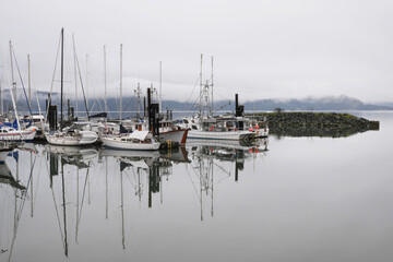 Fototapeta premium Boats docked at the Fishermen's Wharf during a winter season on Vancouver Island in Cowichan Bay, British Columbia, Canada