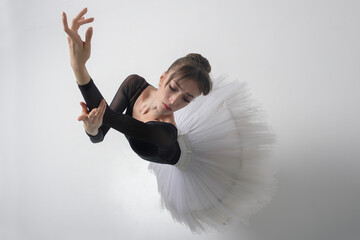 angle from above on a ballerina up to the waist with her hands showing a dance