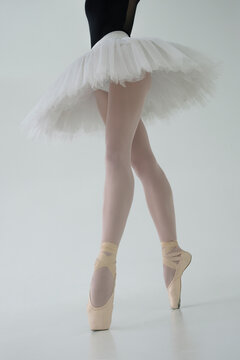 photo of a ballerina's legs in pointes showing a pa during a performance