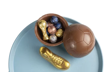 Fototapeten Easter egg in the shape of a soccer ball filled with small assorted chocolates_6. © Ricardo Alves