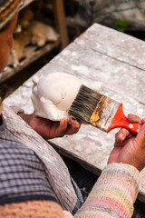 poor woman craftswoman working with plaster crafts in her workshop - entrepreneurship concept