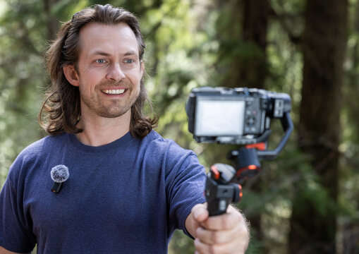 Young man filming with a camera gimbal