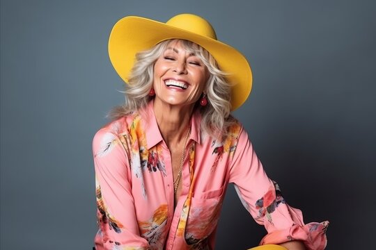 Portrait of a beautiful senior woman wearing summer clothes and yellow hat