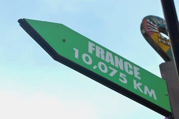 Close-up shots of directional signs pointing towards the enchanting destinations of the France
