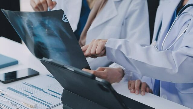 Qualified woman doctor in white uniform checking x-ray film, diagnose patient injury, smiling calm and standing isolated on studio background with copy space. Healthcare and medical insurance concept