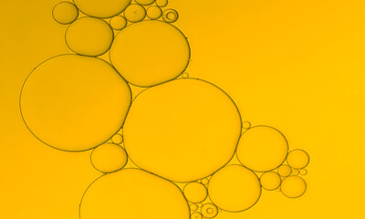 Golden yellow colour of the oil bubbles pattern background. 