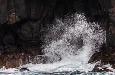The moment the waves hit the coastal cliff. bubbles, splash