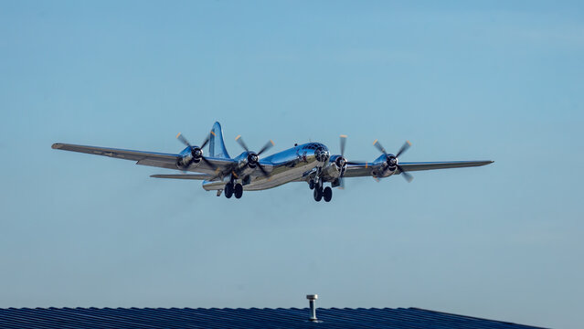front right view of B-29 bomber Doc with gear extended as it approaches the rnway