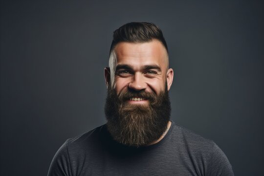 Portrait of a handsome man with long beard and mustache. Isolated on dark background.