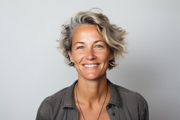 Portrait of a happy middle-aged woman with short grey hair