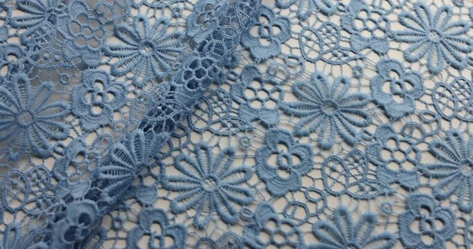 Blue lace fabric features intricate floral pattern