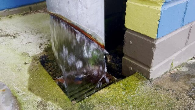 4K vide of  during a heavy rainfall event with the massive runoff pouring into a pipe stormwater drain system