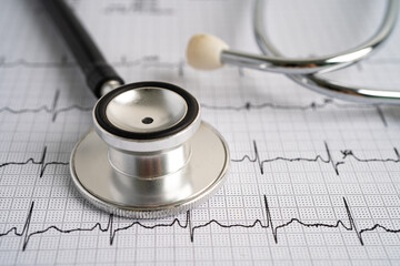 Stethoscope on electrocardiogram ECG, heart wave, heart attack, cardiogram report.