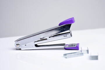 purple stapler or staples isolated on a white background