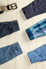 Sleeves of different men's shirts on a wooden background. - 764465020