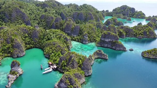 Aerial view of the beautiful turquoise water of the lagoon with green rocky hills in Piaynemo, Raja Ampat, Indonesia