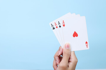 Hand Holds Hand Poker Cards Isolated Blue Background.