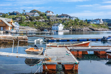 Glesvær marina dock with rusted pier and wooden boats in a fishing village on a coast of the sea