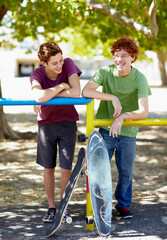 Teenager boy, friends and happy with skateboard in park for summer, vacation and relax by trees. Gen z people, skater and smile at playground for outdoor sport with social conversation in Vancouver © Kimberly Hale/peopleimages.com