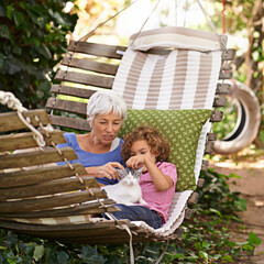 Backyard, grandmother and boy with cat, relax and sunshine with weekend break and vacation. Family,...