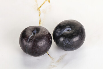 Two ripe sweet black plums