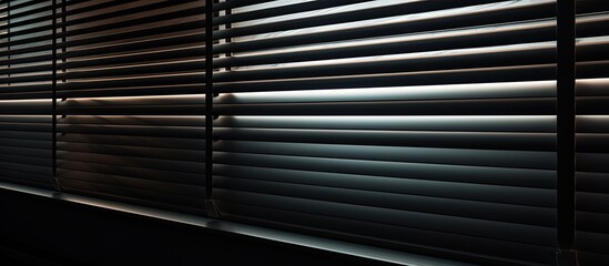 Capture the details of a window with closed blinds in a dark room with minimal lighting