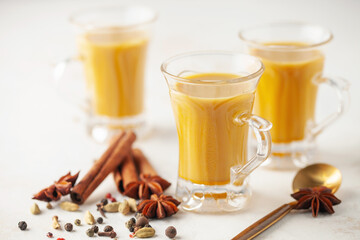Golden Cinnamon  Turmeric Milk. Trendy hot Healthy drink with turmeric roots and spices. Indian...