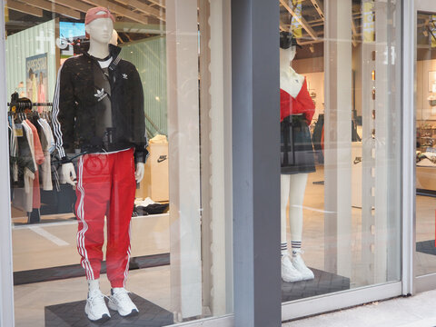 TOKYO, JAPAN - March 16, 2024: ABC Mart Grand Stage store window display featuring Adidas clothes and sneakers in Tokyo's Ginza area.