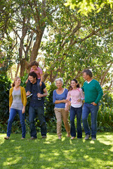 Happy family, conversation and together in outdoor nature, love and bonding or relax in backyard. Generations, smile and peace or communication for support in garden or park, vacation and holiday