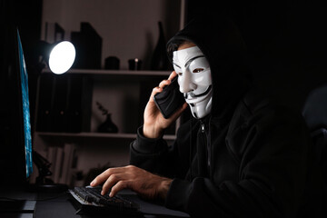 White smiling criminal anonymous mask calling to victim, convince to hack personal information,...