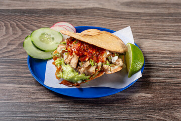 A view of a Mexican vampiro taco with pollo asado.