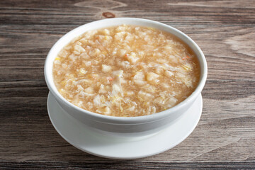A view of a bowl of crab and fish maw soup.