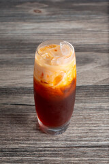 A view of a glass of Thai tea.