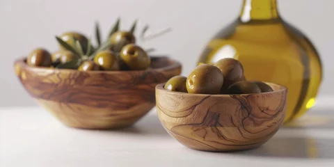 Foto op Plexiglas Two wooden bowls filled with olives sit on white table next to bottle of oli © vefimov
