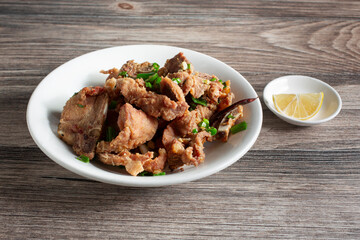 A view of a plate of salt and pepper pork chops.