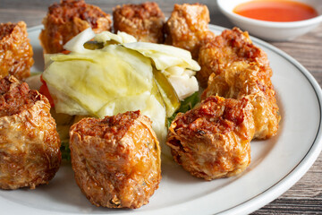 A closeup view of a plate of deep fried prawn balls.