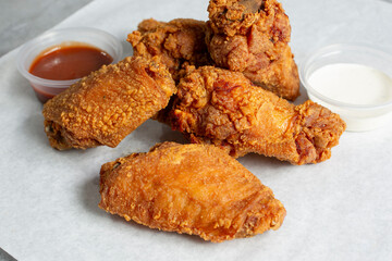 A closeup view of deep fried chicken wings.