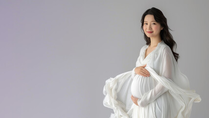 Asian pregnant woman with pregnancy belly, in soft white clothes