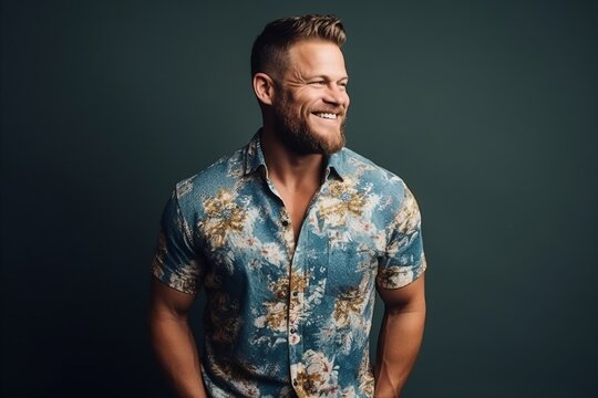 Handsome young man in a floral shirt. Studio shot.