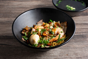 A view of a bowl of combo dry noodle.