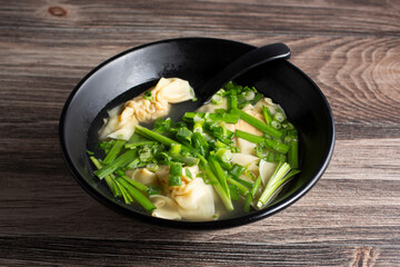 A view of a bowl of sui gow soup.