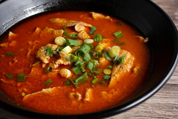 A closeup view of a bowl of chicken satay egg noodle.