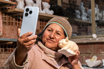 adult female artisan worker taking a selfie - working concept
